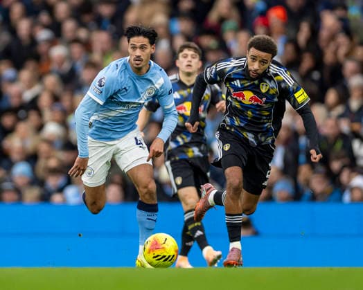29th November 2025; Etihad Stadium, Manchester, Lancashire, England; Premier League Football, Manchester City versus Leeds United; Tijjani Reijnders of Manchester City under pressure from Jayden Bogle of Leeds United  TimxWilliams