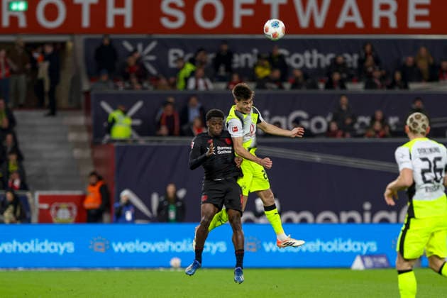 Leverkusen, Germany, 29 11 25 Ernest Poku Bayer 04 Leverkusen and Aaron Anselmino Borussia Dortmund fighting for the ball during the Bundesliga match between Bayer 04 Leverkusen and Borussia Dortmund at BayArena Leverkusen BayArena North Rhine Westphalia Germany Copyright: xBrauer-Fotoagenturx xAdrianxSchlx