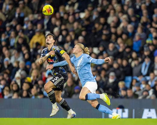 29th November 2025; Etihad Stadium, Manchester, Lancashire, England; Premier League Football, Manchester City versus Leeds United; Pascal Struijk of Leeds United under pressure from Erling Haland of Manchester City  TimxWilliams
