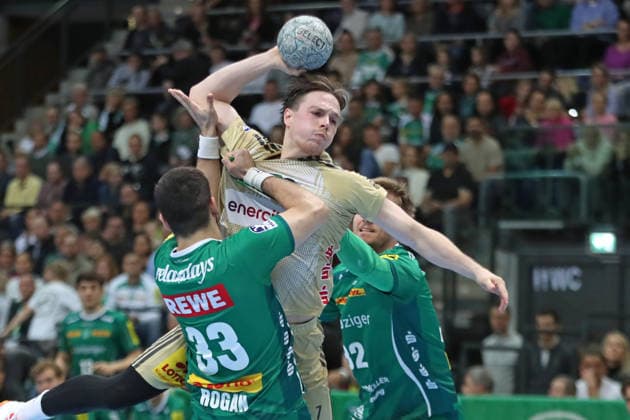 Handball DAIKIN HBL, SC DHfK Leipzig TSV Hannover Burgdorf 30 11 2025 Leif Tissier 7, Hannover Burgdorf is grabbed by Luka Rogan 33, SC DHfK Leipzig Handball, DAIKIN HBL, 1 Bundesliga, Season 2025 2026, 14 Matchday SC DHfK Leipzig vs TSV Hannover Burgdorf on 30 11 2025 at Quarterback Immobilien Arena Leipzig Copyright: xBEAUTIFULxSPORTS JanxKaeferx