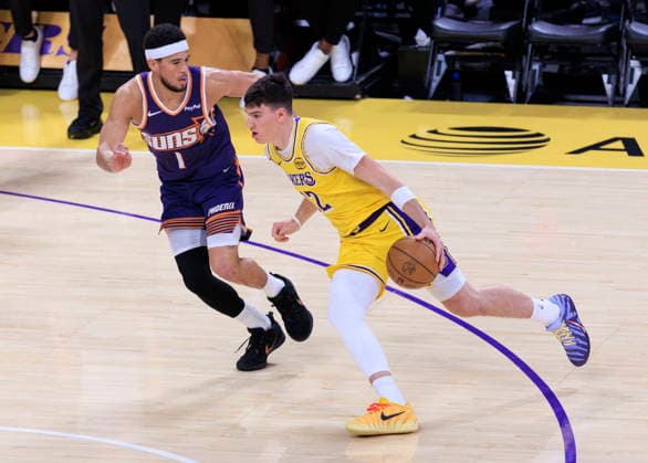 December 1, 2025, Los Angeles, California, USA: Jake LaRavia 12 of the Los Angeles Lakers drives past Devin Booker 1 of the Phoenix Suns during their regular season NBA, Basketball Herren, USA game on Monday December 1, 2025 at Crypto.com Arena in Los Angeles, California. ARIANA RUIZ PI Los Angeles USA - ZUMAp124 20251201_zaa_p124_010 Copyright: xArianaxRuizx