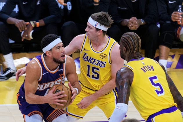 December 1, 2025, Los Angeles, California, USA: Devin Booker 1 of the Phoenix Suns attempts a drive as Austin Reaves 15 and Deandre Ayton 5 of the Los Angeles Lakers defend during their regular season NBA, Basketball Herren, USA game on Monday December 1, 2025 at Crypto.com Arena in Los Angeles, California. ARIANA RUIZ PI Los Angeles USA - ZUMAp124 20251201_zaa_p124_011 Copyright: xArianaxRuizx