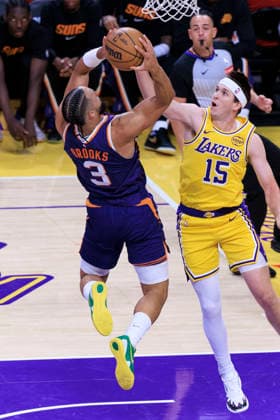 December 1, 2025, Los Angeles, California, USA: Dillon Brooks 3 of the Phoenix Suns makes a two point shot as Austin Reaves 15 of the Los Angeles Lakers defends the basket during their regular season NBA, Basketball Herren, USA game on Monday December 1, 2025 at Crypto.com Arena in Los Angeles, California. ARIANA RUIZ PI Los Angeles USA - ZUMAp124 20251201_zaa_p124_015 Copyright: xArianaxRuizx