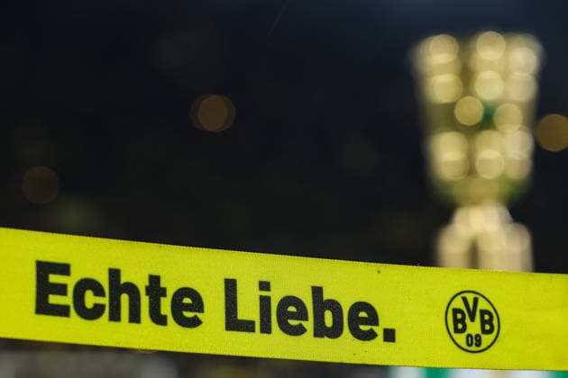Soccer DFB Cup Borussia Dortmund Bayer 04 Leverkusen on 02 12 2025 at the Signal Iduna Park in Dortmund DFB Pokal Trophy Trophy in the background in front the lettering Echte Liebe and with BVB logo feature, symbol, symbolic photo, characteristic, detail MH