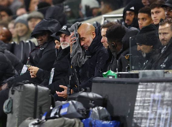London, England, 2nd December 2025. Pep Guardiola coach of Manchester City wipes his face in the rain during the Fulham vs Manchester City Premier League match at Craven Cottage, London. Picture credit should read: Nigel Roddis Sportimage EDITORIAL USE ONLY. No use with unauthorised audio, video, data, fixture lists, club league logos or live services. Online in-match use limited to 120 images, no video emulation. No use in betting, games or single club league player publications. SPI_019_PT_Fulham_Man_City SPI-4339-0019