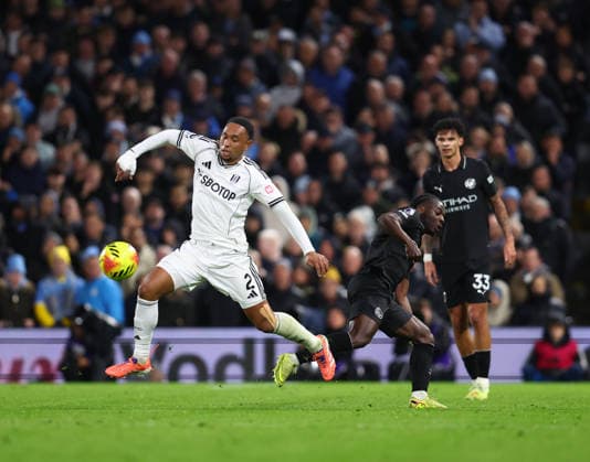 London, England, 2nd December 2025. Kenny Tete of Fulham challenges Jeremy Doku of Manchester City during the Fulham vs Manchester City Premier League match at Craven Cottage, London. Picture credit should read: Nigel Roddis Sportimage EDITORIAL USE ONLY. No use with unauthorised audio, video, data, fixture lists, club league logos or live services. Online in-match use limited to 120 images, no video emulation. No use in betting, games or single club league player publications. SPI_023_PT_Fulham_Man_City SPI-4339-0023