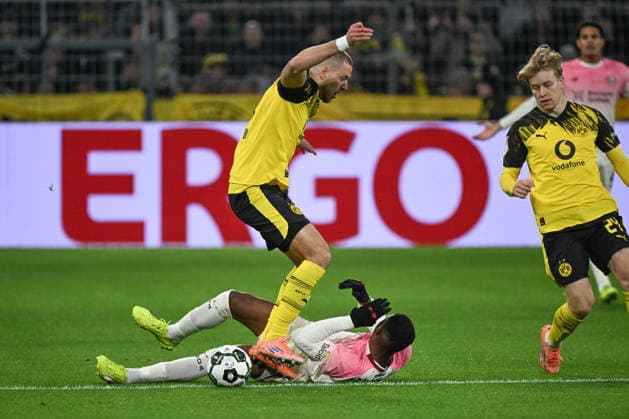 02 12 2025, xjhx, Football DFB Cup Round of 16, Borussia Dortmund Bayer 04 Leverkusen emspor, v l Waldemar Anton Dortmund, 3 , Christian Michel Kofane Leverkusen, 35 duel, fight, tackle DFL DFB REGULATIONS PROHIBIT ANY USE OF PHOTOGRAPHS as IMAGE SEQUENCES and or QUASI VIDEO Dortmund