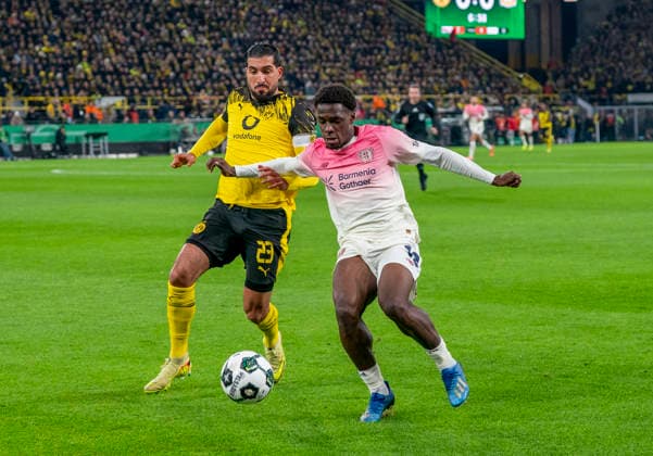 duel between Emre CAN Borussia Dortmund, 23 and Ernest POKU Bayer 04 Leverkusen, 19 Borussia Dortmund Bayer Leverkusen, DFB Pokal Round of 16 in Dortmund, Signal Iduna Park DFL regulations prohibit any use of photographs as image sequences and or quasi video Copyright: HMBxMedia xMarcoxBader