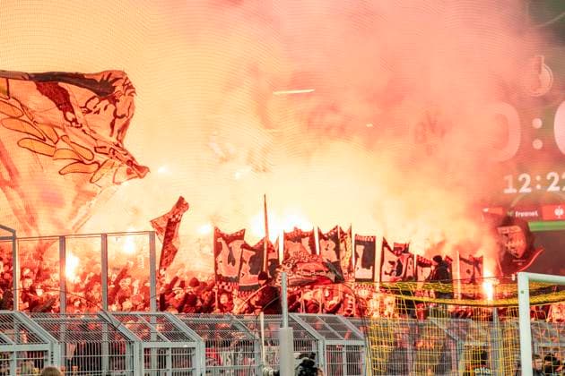 Guest fans with pyrotechnics Fans of Bayer Leverkusen, in the background the scoreboard with the 12 minute Guest fans with pyrotechnics Fans of Bayer Leverkusen, in the background the scoreboard with the 12 minute Borussia Dortmund Bayer Leverkusen, DFB Pokal Achtelfinale Round of 16 in Dortmund, Signal Iduna Park DFL regulations prohibit any use of photographs as image sequences and or quasi video Copyright: HMBxMedia xMarcoxBader