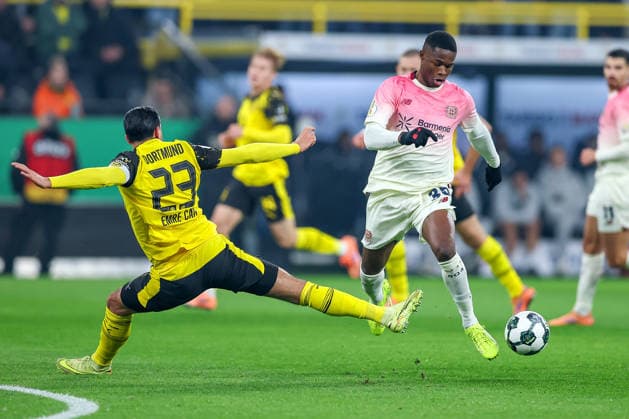 02 12 2025, Football, DFB Cup, Borussia Dortmund Bayer 04 Leverkusen, Round of 16, Signal Iduna Park, Season 2025 2026 Emre Can BVB 23 in duel against Christian Kofane Bayer04 35 DFB regulations prohibit any use of photographs as image sequences and or quasi video North Rhine-Westphalia Germany