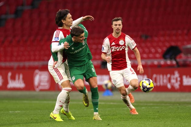Ko Itakura of AFC Ajax battles for the ball with Brynjolfur Willumsson of FC Groningen during the match AFC Ajax Amsterdam vs FC Groningen at the Johan Cruijff ArenA for the Dutch Vriendenloterij Eredivisie season 2025 2026 in AMSTERDAM, Netherlands on 1 december 2025, photo by Peter Lous EYE4images DeFodi Images