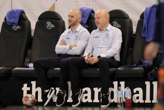 photo smalltalk before kick-off , Physiotherapist Alain Carmand , left next to him Co Coach Baptiste Nicot Handball Men on Tue 02 12 2025 Euroleague Mens EHF EURO LEAGUE , Tue 02 12 25 THW Kiel Montpellier HB
