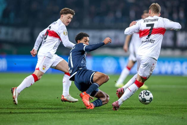 02 12 2025, Football, DFB Cup, , Season 2025 2026 Francis Onyeka VfL Bochum 21 in duel against Angelo Stiller VfB Stuttgart 06 Maximilian Mittelstädt VfB Stuttgart 07 DFB regulations prohibit any use of photographs as image sequences and or quasi video North Rhine-Westphalia Germany