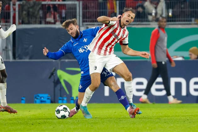 Killian Corredor SV Darmstadt , 34 and Max Rosenfelder SC Freiburg, 37 in duel , Germany, Soccer, DFB Cup, Round of 16, 2025 2026, SC Freiburg vs SV Darmstadt 98, 03 12 2025, Europa Park Stadion , Freiburg im Breisgau, Germany Freiburg im Breisgau Europa Park Stadion Baden Wuerttemberg Germany Copyright: xGrantxHubbsx