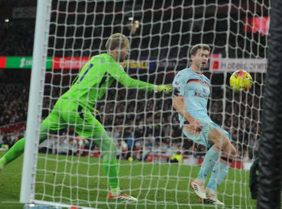 Football - 2025 2026 Premier League - Arsenal vs Brentford - Emirates Stadium - Wednesday 3rd December 2025 Brenford goalkeeper, Caoimhin Kelleher and Sepp van den Berg are unable to stop Bukayo Saka - Arsenal from scoring goal no 2 