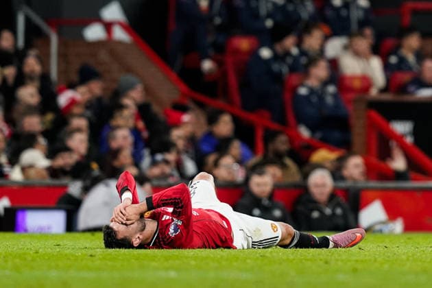 Manchester, England, 4th December 2025. Bruno Fernandes of Manchester United, ManU goes down holding his face during the Manchester United vs West Ham United Premier League match at Old Trafford, Manchester. Picture credit should read: Andrew Yates Sportimage EDITORIAL USE ONLY. No use with unauthorised audio, video, data, fixture lists, club league logos or live services. Online in-match use limited to 120 images, no video emulation. No use in betting, games or single club league player publications. SPI_018_AY_MANUTD_WESTHAM SPI-4345-0019