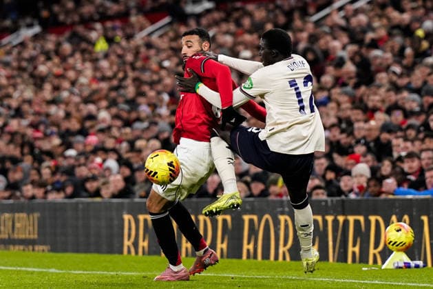 Manchester, England, 4th December 2025. Noussair Mazraoui of Manchester United, ManU and El Hadji Malick Diouf of West Ham United battle for the ball during the Manchester United vs West Ham United Premier League match at Old Trafford, Manchester. Picture credit should read: Andrew Yates Sportimage EDITORIAL USE ONLY. No use with unauthorised audio, video, data, fixture lists, club league logos or live services. Online in-match use limited to 120 images, no video emulation. No use in betting, games or single club league player publications. SPI_047_AY_MANUTD_WESTHAM SPI-4345-0048