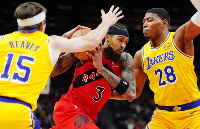 December 4, 2025, Toronto, On, Canada: Toronto Raptors Brandon Ingram (3) drives between Los Angeles Lakers Austin Reaves (15) and Rui Hachimura (28) during first half NBA, Basketball Herren, USA basketball action in Toronto on Thursday, Dec. 4, 2025. Canada News - December 4, 2025  - ZUMAc35_ 20251204_zaf_c35_121 Copyright: xFrankxGunnx