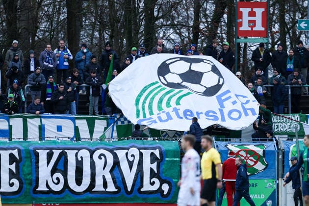 06 12 2025, xKWIx, Football, Regionalliga West, FC Gütersloh RW Oberhausen, Ohlendorf Stadion im Heidewald FC Gütersloh fans present the old logo in the block Photo xKamilxWilkowskixPressefotoKochx NRW Germany