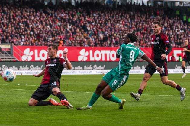 Noel Futkeu 9 Spvgg Greuther Fuerth shoots on goal, with Robin Knoche 31 1FC Nuernberg and Adam Markhiyev 6 1FC Nuernberg , 1 FC Nuernberg vs Spvgg Greuther Fuerth, Football, 2 Bundesliga, DFL, Season 2025 2026, Hinrunde, 15 Matchday, 07 12 2025 DFB regulations prohibit any use of photographs as image sequences and or quasi video Nuernberg Bayern Germany Copyright: xkolbert-press MartinxAgüerax