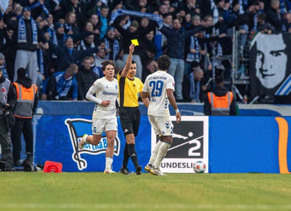Soccer, Men, Season 2025 2026, 2 Bundesliga 15 Matchday , Hertha BSC 1 FC Magdeburg, Referee Konrad Oldhafer shows Ryan Ghrieb Magdeburg the yellow card, 07 12 2025, Copyright: xSebastianxRäppold MatthiasxKochx