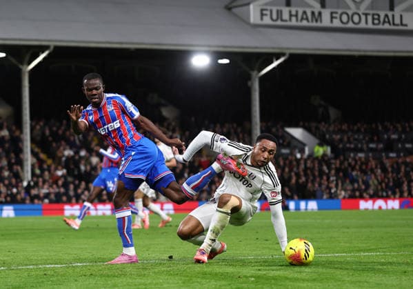 London, England, 7th December 2025. Tyrick Mitchell of Crystal Palace (l) tussles with Kenny Tete of Fulham (r) during the Fulham vs Crystal Palace Premier League match at Craven Cottage, London. Picture credit should read: David Klein Sportimage EDITORIAL USE ONLY. No use with unauthorised audio, video, data, fixture lists, club league logos or live services. Online in-match use limited to 120 images, no video emulation. No use in betting, games or single club league player publications. SPI_030_DK_Fulham_Palace SPI-4355-0029