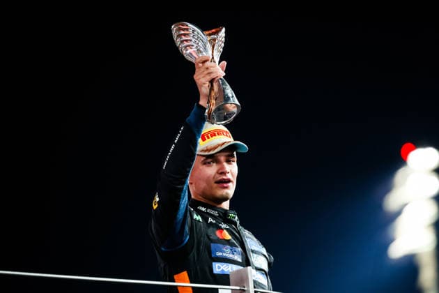 F1 - ABU DHABI GRAND PRIX 2025 04 NORRIS Lando (gbr), McLaren F1 Team MCL39, action celebrating the World Championship, WM, Weltmeisterschaft title on the podium with the trophy during the 2025 Formula 1 Abu Dhabi Grand Prix, 24th round of the 2025 FIA Formula One World Championship from December 05 to 07, 2025 on the Yas Marina Circuit, in Abu Dhabi, United Arab Emirates - Abu DhabiUnited Arab Emirates  Copyright: xFLORENTxGOODENx