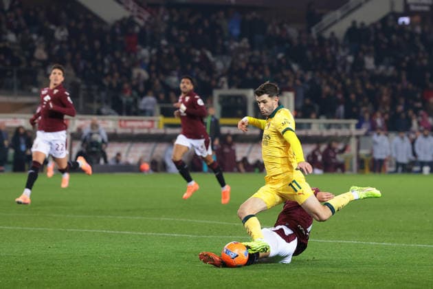 Turin, Italy, 8th December 2025. Christian Pulisic of AC Milan is challenged by Zakaria Aboukhlal of Torino FC as he bears down on goal during the Torino vs AC Milan Serie A match at Stadio Grande Torino, Turin. Picture credit should read: Jonathan Moscrop Sportimage EDITORIAL USE ONLY. No use with unauthorised audio, video, data, fixture lists, club league logos or live services. Online in-match use limited to 120 images, no video emulation. No use in betting, games or single club league player publications. SPI_089_JM_TORO_MILAN SPI-4323-0089