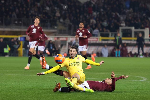 Turin, Italy, 8th December 2025. Christian Pulisic of AC Milan is challenged by Zakaria Aboukhlal of Torino FC as he bears down on goal during the Torino vs AC Milan Serie A match at Stadio Grande Torino, Turin. Picture credit should read: Jonathan Moscrop Sportimage EDITORIAL USE ONLY. No use with unauthorised audio, video, data, fixture lists, club league logos or live services. Online in-match use limited to 120 images, no video emulation. No use in betting, games or single club league player publications. SPI_091_JM_TORO_MILAN SPI-4323-0091