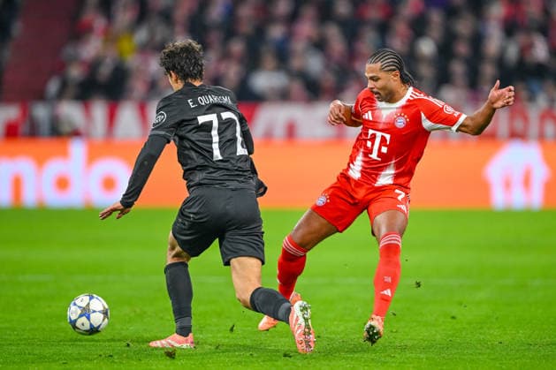 Eduardo Quaresma Sporting CP and Serge Gnabry FC Bayern München battle for the ball during the UEFA Champions League 2025 26 League Phase MD6 match between FC Bayern München and Sporting Clube de Portugal at Football Arena Munich on December 9, 2025 in Munich, Germany Photo by xxx DeFodi Images