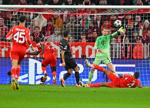 09 12 2025, Football UEFA Championsleague 2025 2026 Preliminary Round 6 Matchday, FC Bayern Munich Sporting Lisbon, in the Allianz Arena Munich Goalkeeper Manuel Neuer FC Bayern Munich defends the ball Almost an own goal by Jonathan Tah FC Bayern Munich DFL and DFB regulations prohibit any use of photographs as image sequences and or quasi video