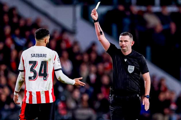 referee Michael Oliver shows a yellow card to Ismael Saibari of PSV Eindhoven PSV Eindhoven v Atletico de Madrid, UEFA Champions League 2025 26 League Phase MD6, PSV Eindhoven v Atletico de Madrid, PSV Stadion, December 9, 2025, Eindhoven, Netherlands.