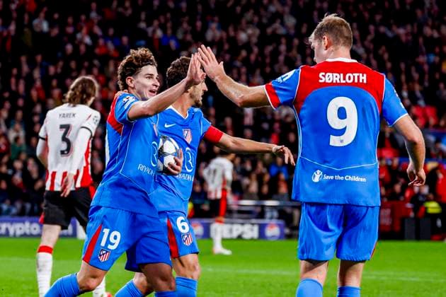 Julian Alvarez of Atletico Madrid celebrates with teammates after scoring his teams first goal and Yarek Gasiorowski of PSV Eindhoven looks dejected after conceding his sides first goal PSV Eindhoven v Atletico de Madrid, UEFA Champions League 2025 26 League Phase MD6, PSV Eindhoven v Atletico de Madrid, PSV Stadion, December 9, 2025, Eindhoven, Netherlands.