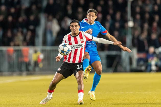 Couhaib Driouech PSV Eindhoven and Nahuel Molina Atletico Madrid battle for the ball during the UEFA Champions League 2025 26 League Phase MD6 match between PSV Eindhoven and Atletico de Madrid at PSV Stadion on December 9, 2025 in Eindhoven, Netherlands