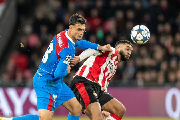 Marc Pubill Atletico Madrid and Ismael Saibari PSV Eindhoven battle for the ball during the UEFA Champions League 2025 26 League Phase MD6 match between PSV Eindhoven and Atletico de Madrid at PSV Stadion on December 9, 2025 in Eindhoven, Netherlands
