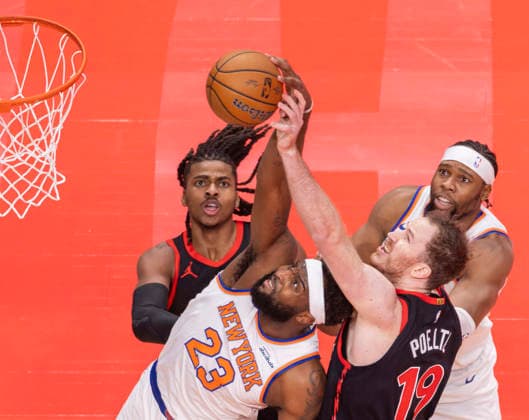 (251210) -- TORONTO, Dec. 10, 2025 -- Jakob Poeltl (front R) of Toronto Raptors fights for a rebound with Mitchell Robinson (front L) of New York Knicks during the 2025-2026 NBA, Basketball Herren, USA Cup quarterfinal match between Toronto Raptors and New York Knicks in Toronto, Canada, on Dec. 9, 2025. (Photo by Xinhua) (SP)CANADA-TORONTO-BASKETBALL-NBA CUP-KNICKS VS RAPTORS ZouxZheng 