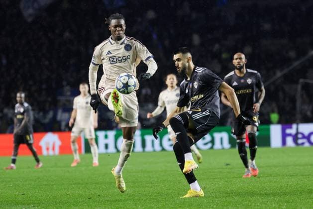 BAKU , 10-12-2025 , Tofiq Bahramov Stadion , Season 2025 2026 , UEFA Champions League football , match between FK Qarabag and Ajax Amsterdam , picture shows Ajax player Don-Angelo Konadu and Qarabag FK player Nariman Akhundzade Qarabag - Ajax  x200104606x Copyright: