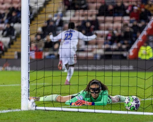 10th December 2025; Leigh Sports Village, Manchester, England; Womens Champions League Football, Manchester United, ManU versus Lyon Women; Goalkeeper Safia Middleton-Patel of Manchester United Women looks at the ball in the back of the net as Tabitha Chawinga of OL Lyonnes celebrates her goal  TimxWilliams