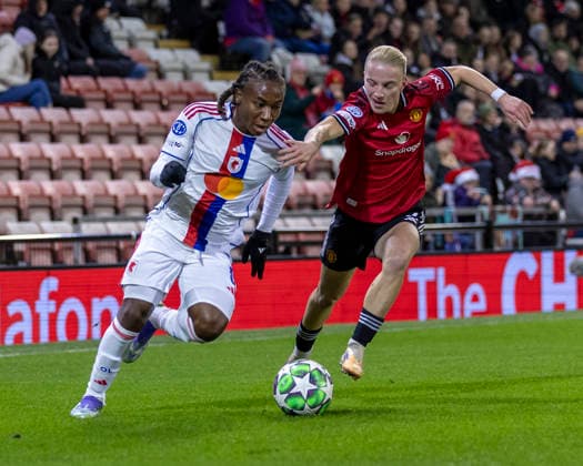 10th December 2025; Leigh Sports Village, Manchester, England; Womens Champions League Football, Manchester United, ManU versus Lyon Women; Melchie Dumornay of OL Lyonnes under pressure from Anna Sandberg of Manchester United Women  TimxWilliams