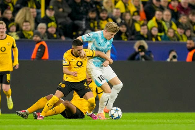 Jobe Bellingham Borussia Dortmund and Jens Petter Hauge FK Bodo Glimt and Yan Couto Borussia Dortmund battle for the ball during the UEFA Champions League 2025 26 League Phase MD6 match between Borussia Dortmund and FK Bodo Glimt at BVB Stadion Dortmund on December 10, 2025 in Dortmund, Germany Photo by Alex Gottschalk DeFodi Images