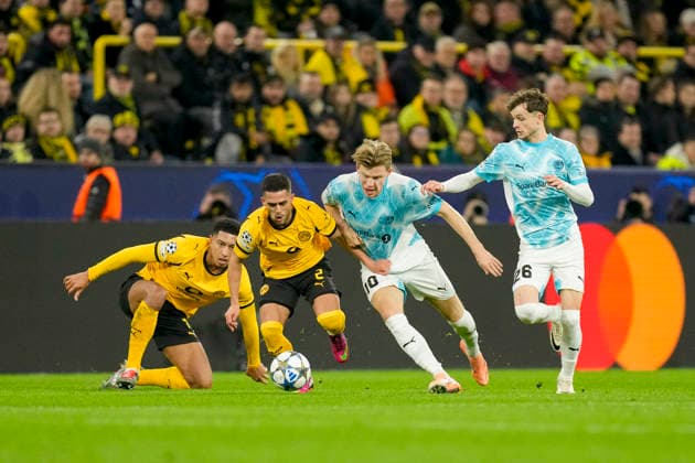 Jobe Bellingham Borussia Dortmund and Jens Petter Hauge FK Bodo Glimt and Yan Couto Borussia Dortmund and Hakon Evjen FK Bodo Glimt battle for the ball during the UEFA Champions League 2025 26 League Phase MD6 match between Borussia Dortmund and FK Bodo Glimt at BVB Stadion Dortmund on December 10, 2025 in Dortmund, Germany Photo by Alex Gottschalk DeFodi Images