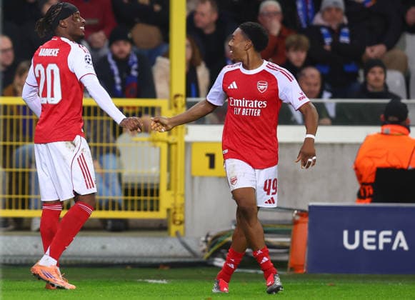 Brugge, Belgium, 10th December 2025. Noni Madueke of Arsenal celebrates with Myles Lewis-Skelly of Arsenal after scoring to make it 2-0 during the Club Brugge vs Arsenal UEFA Champions League match at Jan Breydel Stadium, Brugge. Picture credit should read: Paul Terry Sportimage EDITORIAL USE ONLY. No use with unauthorised audio, video, data, fixture lists, club league logos or live services. Online in-match use limited to 120 images, no video emulation. No use in betting, games or single club league player publications. SPI_045_PT_Brugge_Arsenal SPI-4360-0045