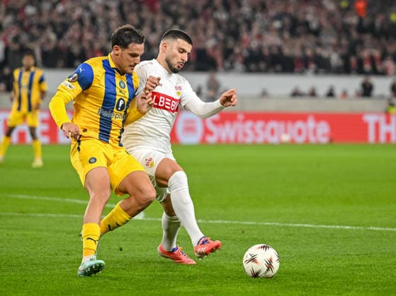 Itai Ben Hamo Maccabi Tel Aviv FC and Deniz Undav VfB Stuttgart battle for the ball during the UEFA Europa League 2025 26 League Phase MD6 match between VfB Stuttgart and Maccabi Tel Aviv FC at Stuttgart Arena on December 11, 2025 in Stuttgart, Germany Photo by Harry Langer DeFodi Images
