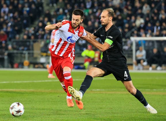 SOCCER - UEFA EL, Sturm vs Red Star GRAZ,AUSTRIA,11.DEC.25 - SOCCER - UEFA Europa League, SK Sturm Graz vs Red Star Belgrade. Image shows Mirko Ivanic (Red Star) and Jon Gorenc-Stankovic (Sturm).  GEPAxpictures xWolfgangxGrebien