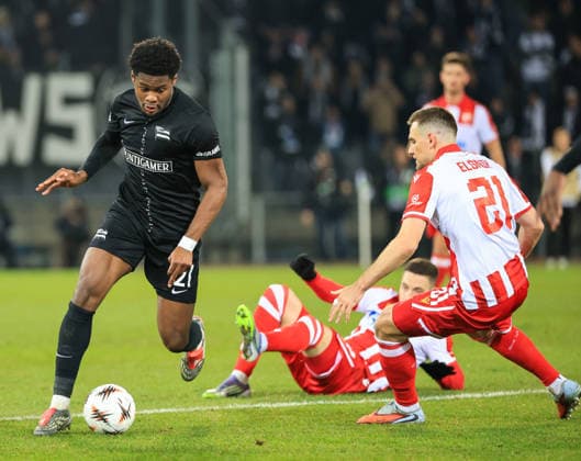 SOCCER - UEFA EL, Sturm vs Red Star GRAZ,AUSTRIA,11.DEC.25 - SOCCER - UEFA Europa League, SK Sturm Graz vs Red Star Belgrade. Image shows Tochi Phil Chukwuani (Sturm) and Timi Elsnik (Red Star).  GEPAxpictures xWolfgangxGrebien