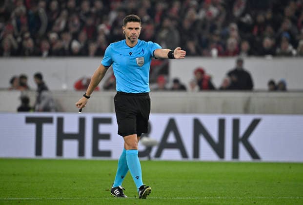 Referee Referee Marian Barbu ROU whistles penalty, penalty kick Gesture Gesture in the background Perimeter advertising Logo THE BANK VfB Stuttgart vs Maccabi Tel Aviv FC EUROPA LEAGUE EL 11 12 2025 DFL REGULATIONS PROHIBIT ANY USE OF PHOTOGRAPHS AS IMAGE SEQUENCES AND OR QUASI VIDEO VfB Stuttgart vs Maccabi Tel Aviv FC EUROPA LEAGUE EL