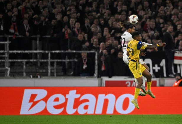 Header duel duel action Helio Varela Maccabi Tel Aviv FC 29 against Lorenz Assignon VfB Stuttgart 22 in the background perimeter advertising Logo BETANO VfB Stuttgart vs Maccabi Tel Aviv FC EUROPA LEAGUE EL 11 12 2025 DFL REGULATIONS PROHIBIT ANY USE OF PHOTOGRAPHS AS IMAGE SEQUENCES AND OR QUASI VIDEO VfB Stuttgart vs Maccabi Tel Aviv FC EUROPA LEAGUE EL