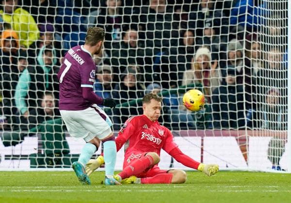 Burnley, England, 13th December 2025. Jacob Bruun Larsen of Burnley has a shot saved by Bernd Leno of Fulham during the Burnley vs Fulham Premier League match at Turf Moor, Burnley. Picture credit should read: Andrew Yates Sportimage EDITORIAL USE ONLY. No use with unauthorised audio, video, data, fixture lists, club league logos or live services. Online in-match use limited to 120 images, no video emulation. No use in betting, games or single club league player publications. SPI_045_AY_Burnley_Fulham SPI-4374-0044