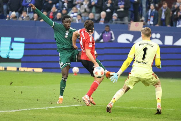 Christian Gomis FC Schalke 04 and Fabio Gruber 1 FC Nürnberg at the match of the 2 Bundesliga season 2025 26 FC Schalke 04 1 FC Nürnberg Copyright Thomas Pakusch