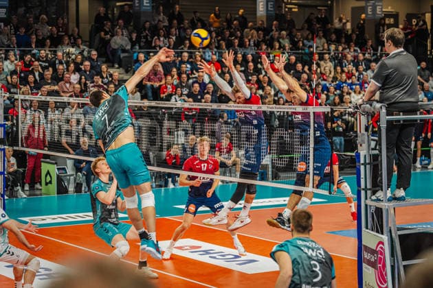 Volleyball mens season 2025 2026 Zoi DVV Cup semi-final SVG Lüneburg vs SWD powervolleys Düren 16 12 2025 Jordan Canham 7 SWD powervolleys Düren against the block of Jackson Howe 6 SVG Lüneburg and Ethan Champlin 20 SVG Lüneburg